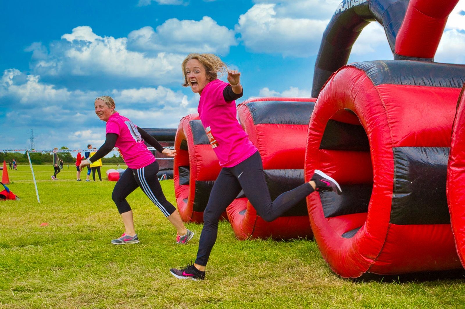 Participants run through huge inflatable red and black tubes