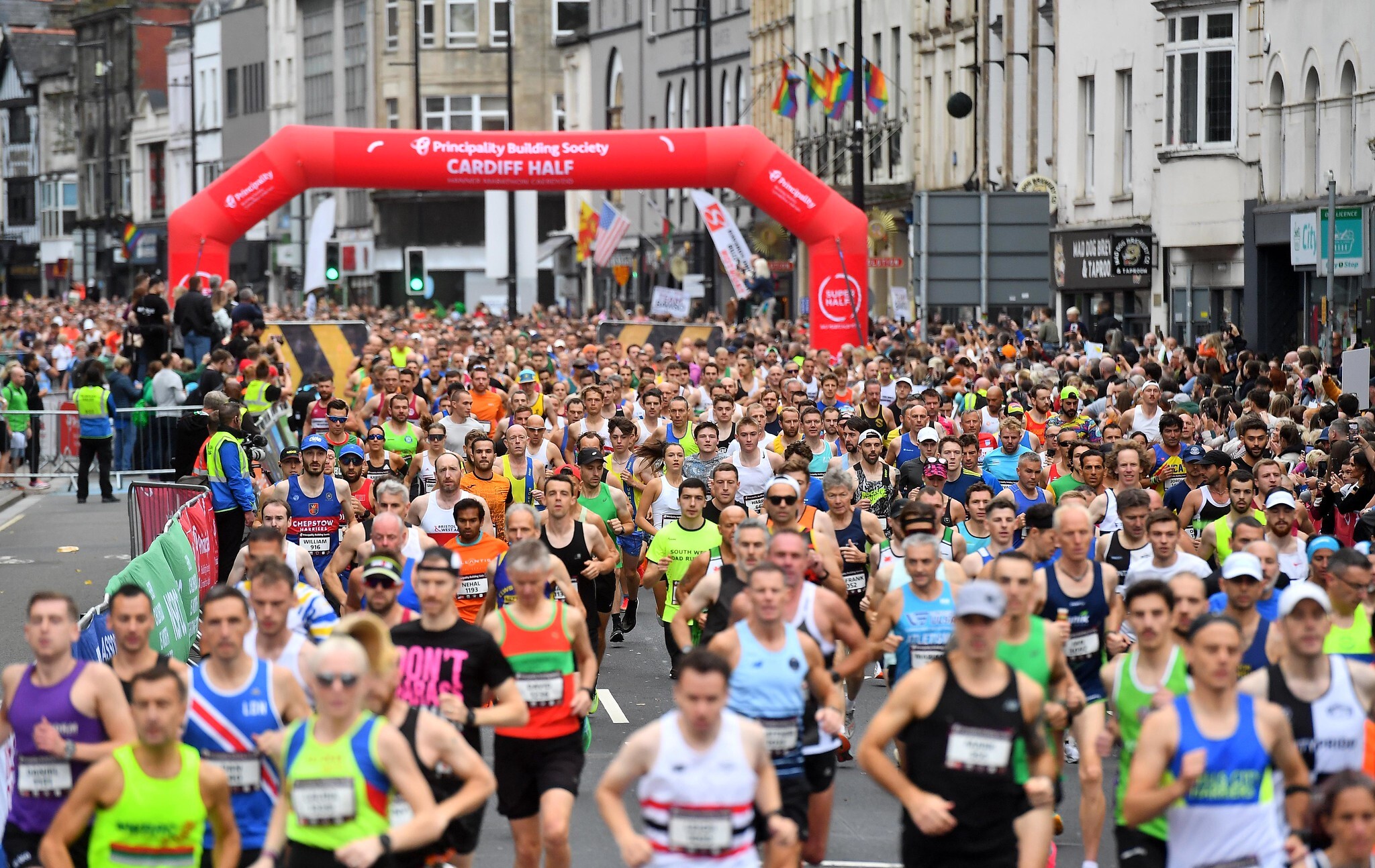 Hundreds of runners at the Cardiff Half Marathon with the start line visible behind them.