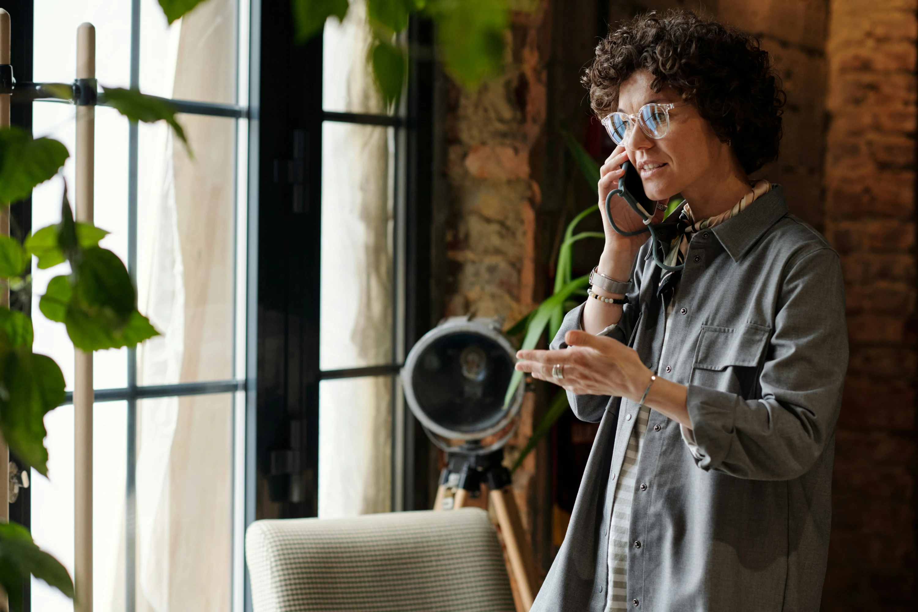 A woman speaks to someone on a mobile phone in a casual setting