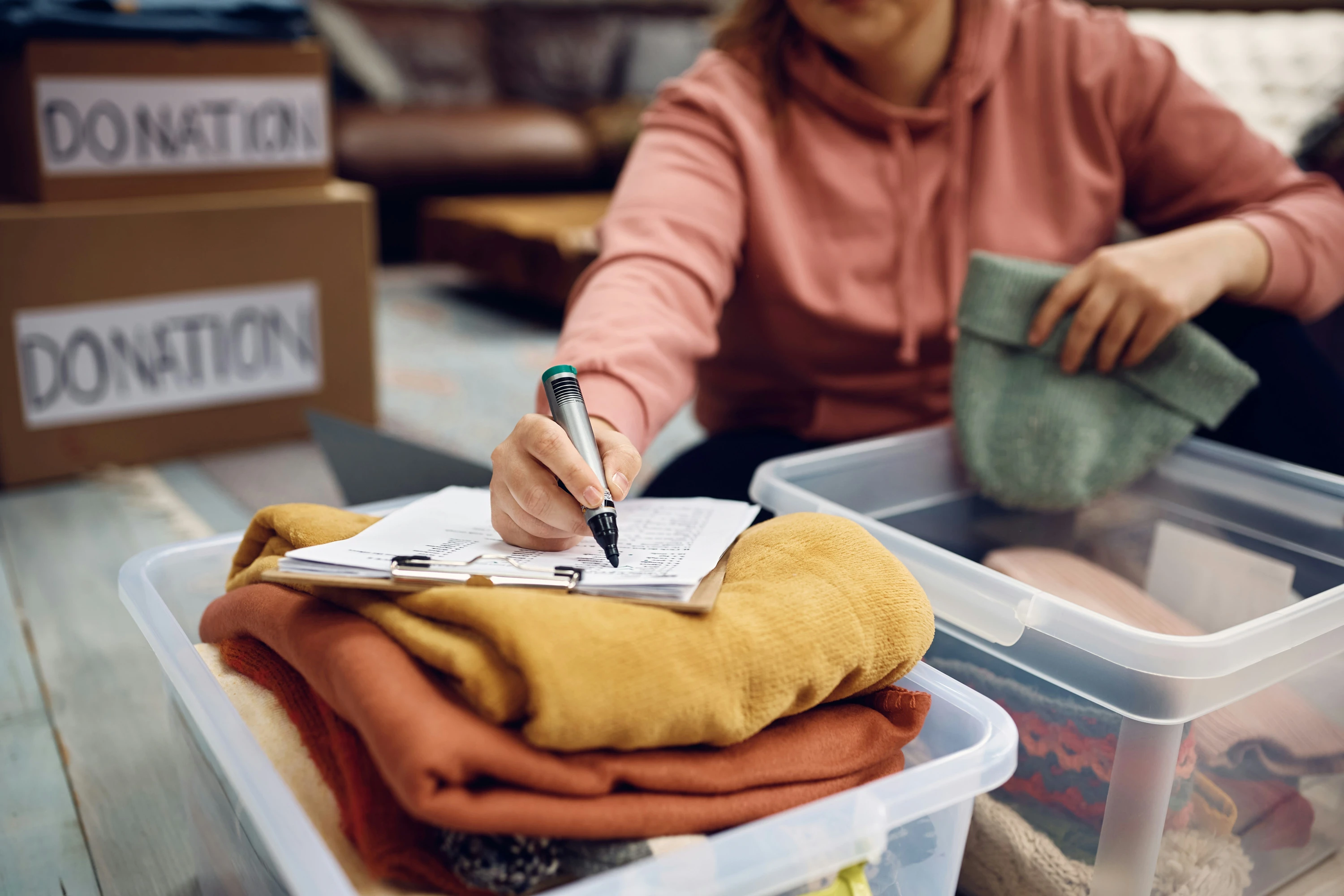 Close-up of a woman checking a list of donations made